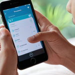 **

A close-up shot of hands interacting with a smartphone displaying a meditation app. Gentle, subtle haptic feedback is visualized as soft, glowing waves emanating from the phone. Focus on conveying a sense of calm, peace and connection. The background should be blurred, subtly hinting at a relaxing environment. Keywords: haptic feedback, meditation, mindfulness, calm, UX design, Malaysian user.

**